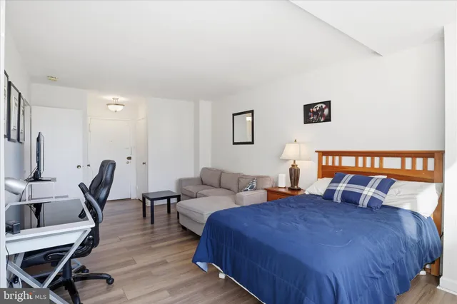 a bedroom with a bed a desk and chair