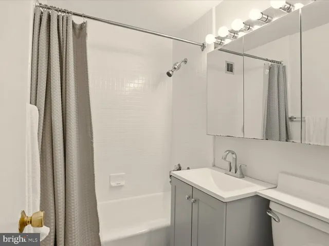 a bathroom with a sink a mirror and a shower