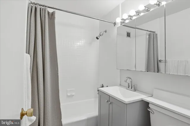a bathroom with a sink a mirror and a shower