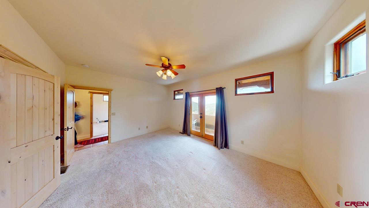 4365 County Road 237 Durango, CO 81301 - Photo 23 of 35 wooden floor in an empty room with a window