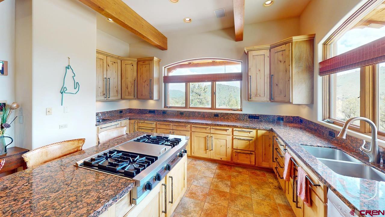 4365 County Road 237 Durango, CO 81301 - Photo 10 of 35 a kitchen with stainless steel appliances granite countertop a sink stove and cabinets