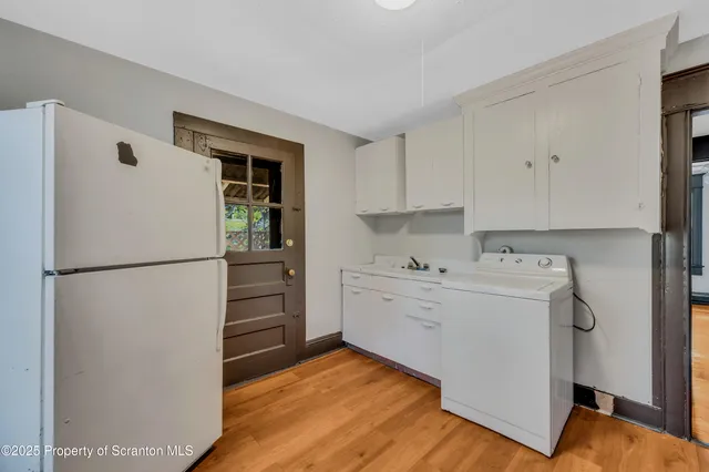 a kitchen with a refrigerator sink stove and cabinets