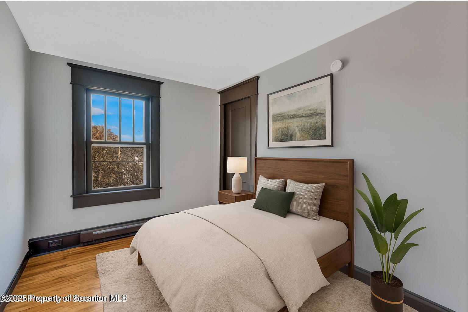 21 Stafford Avenue Scranton, PA 18505 - Photo 9 of 21 a bedroom with a large bed and a potted plant