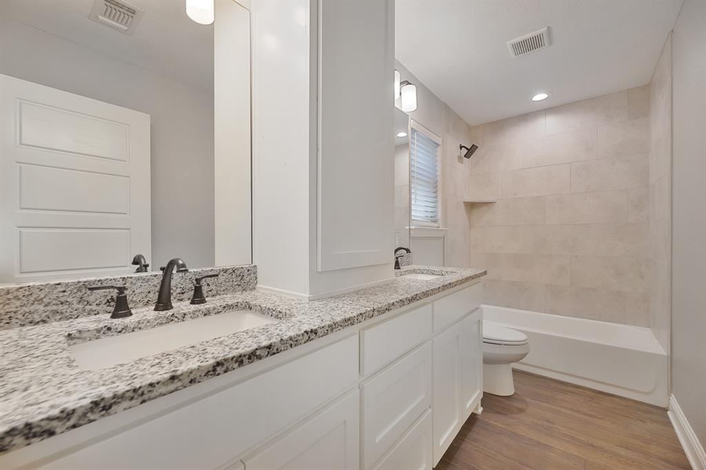 1713 Bronco Road Granbury, TX 76049 - Photo 13 of 23 Dual vanity with stone countertops and undermount sinks