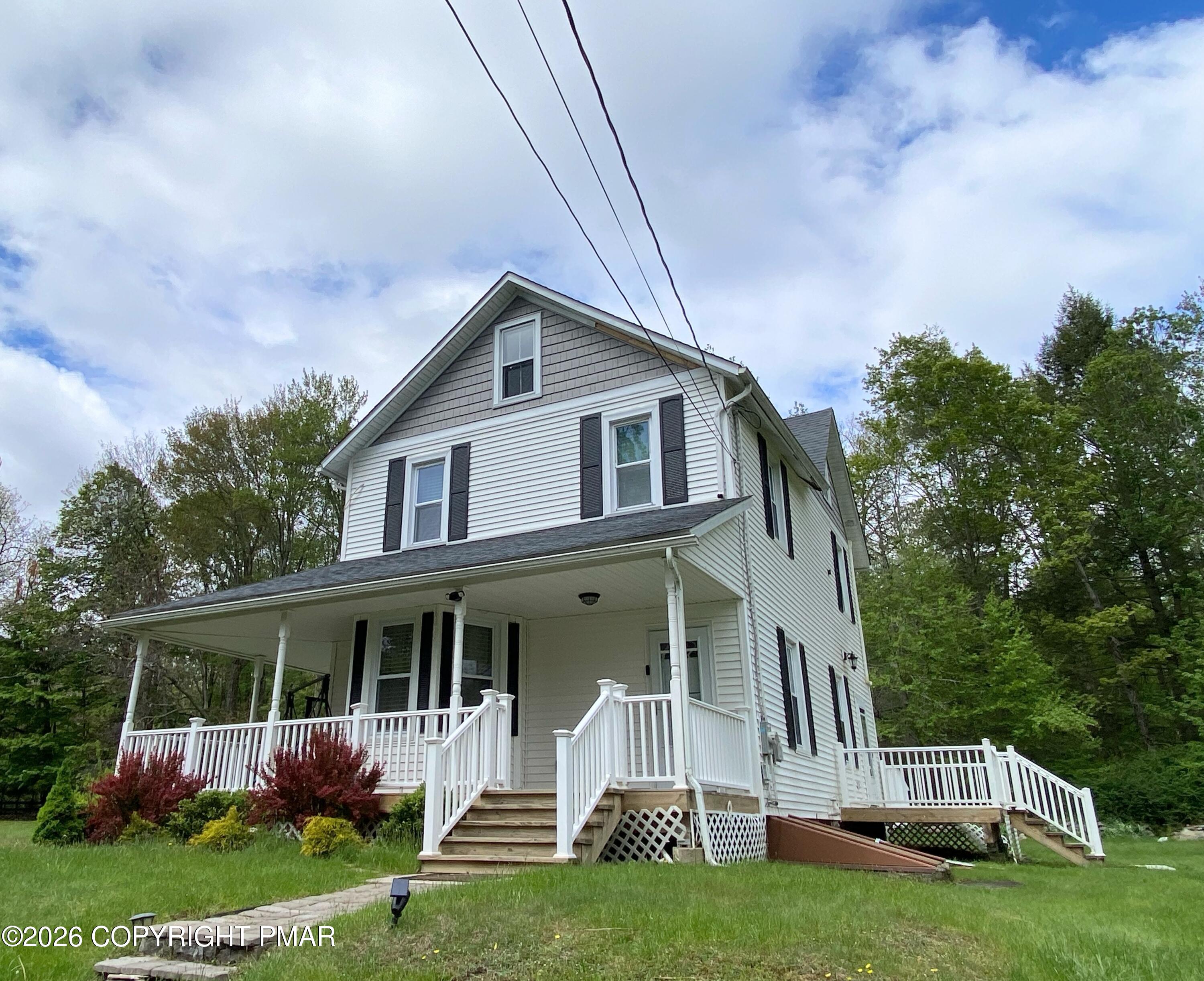 565 Cherry Lane Road East Stroudsburg, PA 18301 - Photo 2 of 16 a front view of house with yard and green space