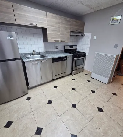 a kitchen with stainless steel appliances a refrigerator sink and cabinets
