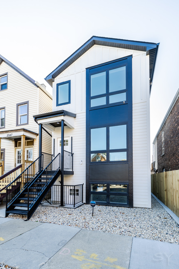 2949 West 25th Place, Unit 1 Chicago, IL 60623 - Photo 1 of 42 a view of wooden house with a large windows