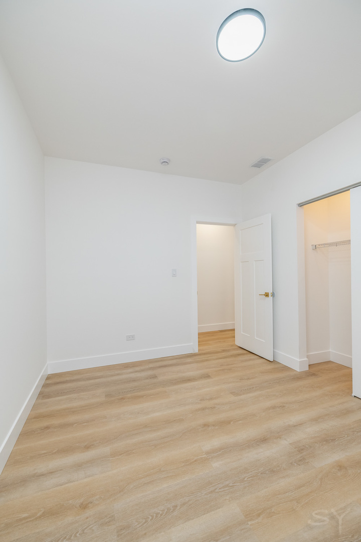 2949 West 25th Place, Unit 1 Chicago, IL 60623 - Photo 20 of 42 a view of an empty room and wooden floor