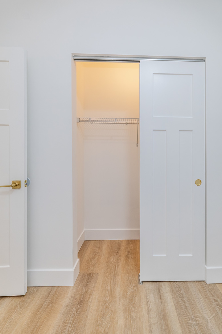 2949 West 25th Place, Unit 1 Chicago, IL 60623 - Photo 21 of 42 an empty room with wooden floor and closet