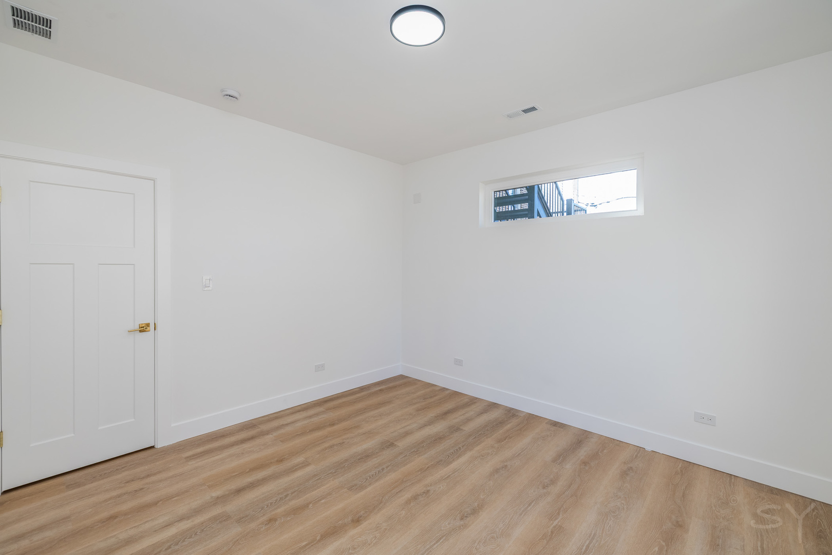 2949 West 25th Place, Unit 1 Chicago, IL 60623 - Photo 33 of 42 a view of a room with wooden floor and white walls