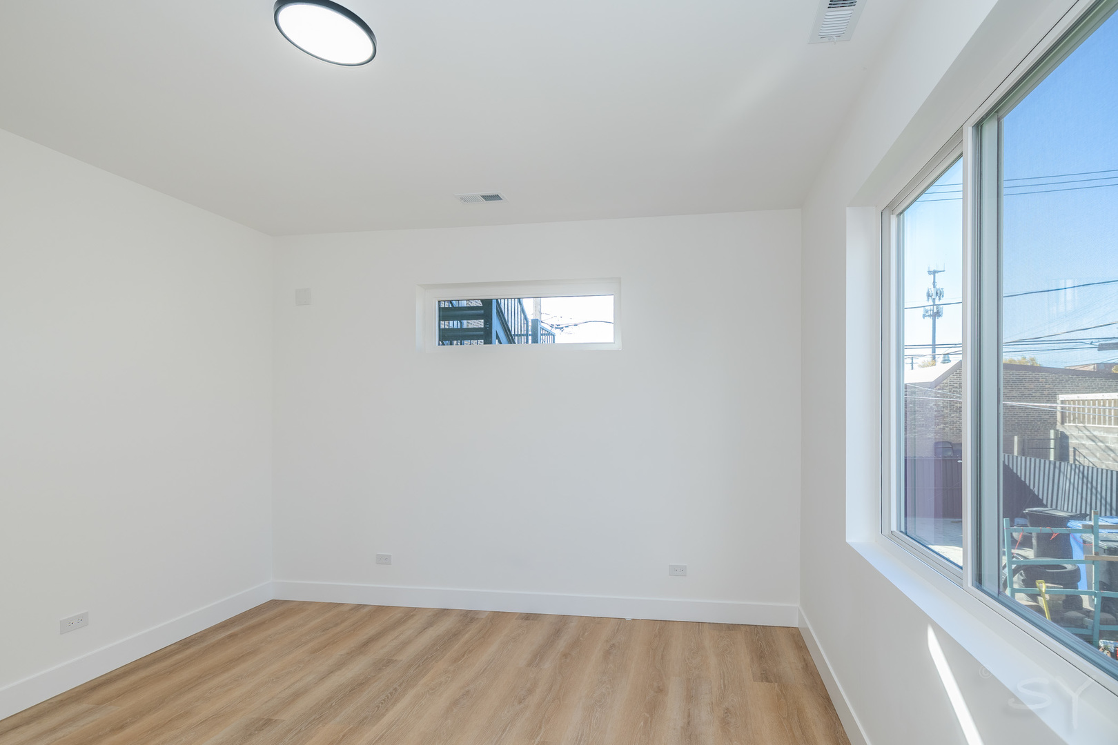 2949 West 25th Place, Unit 1 Chicago, IL 60623 - Photo 34 of 42 a view of a room with wooden floor and window