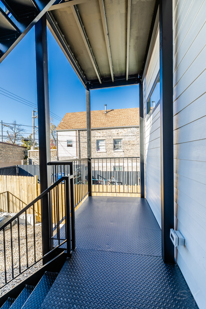 2949 West 25th Place, Unit 1 Chicago, IL 60623 - Photo 42 of 42 a view of an empty room with wooden floor and stairs