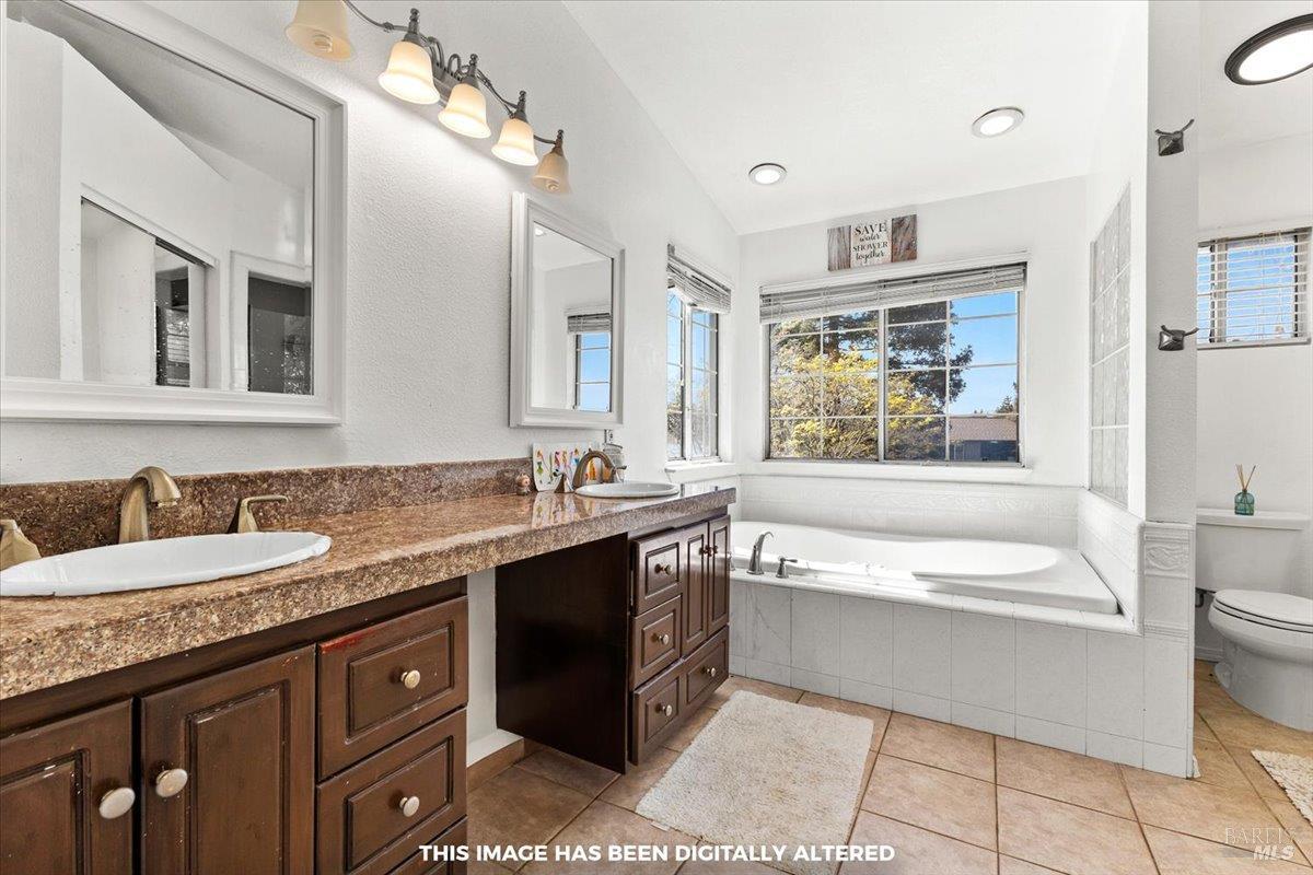 4457 Graywhaler Lane Rohnert Park, CA 94928 - Photo 19 of 51 a spacious bathroom with a granite countertop sink a large mirror and a bathtub