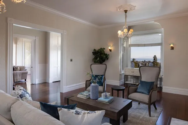 a living room with furniture and a chandelier
