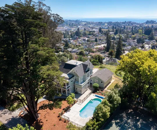 an aerial view of a houses with a street