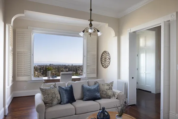 a living room with furniture a window and a clock
