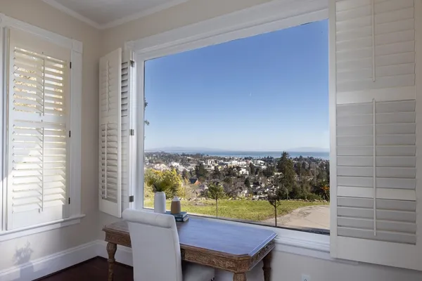 a view of a room with furniture and a window