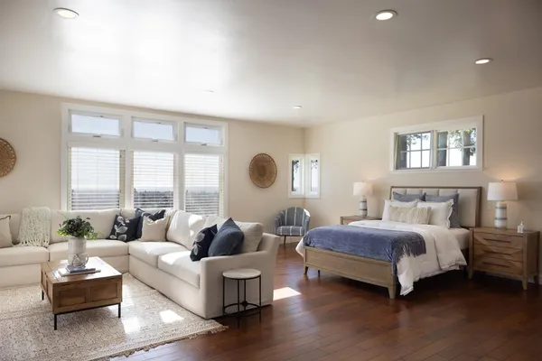 a spacious bedroom with a bed and a couch