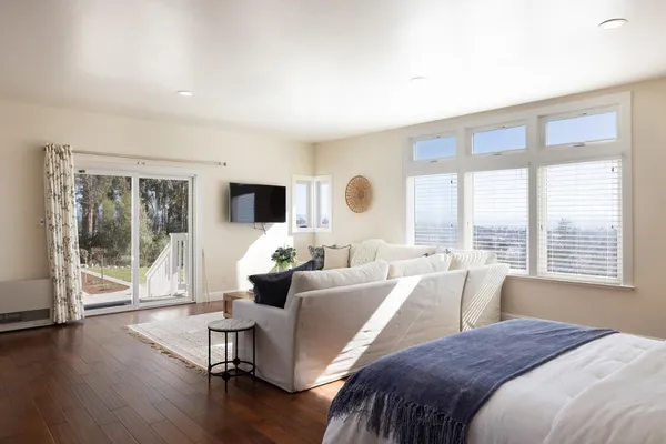 a large bedroom with a large bed and a large window