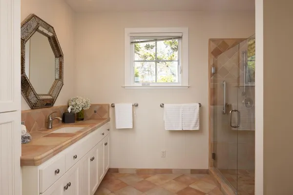 a bathroom with a double vanity sink and a mirror
