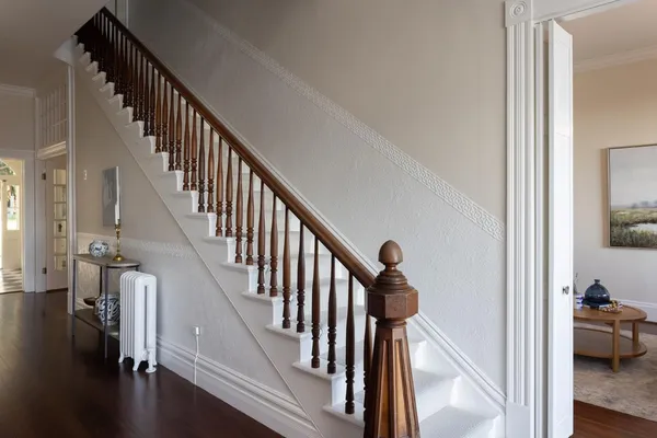 a view of entryway and hall with wooden floor