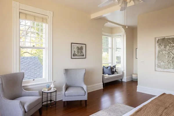 a living room with furniture and wooden floor