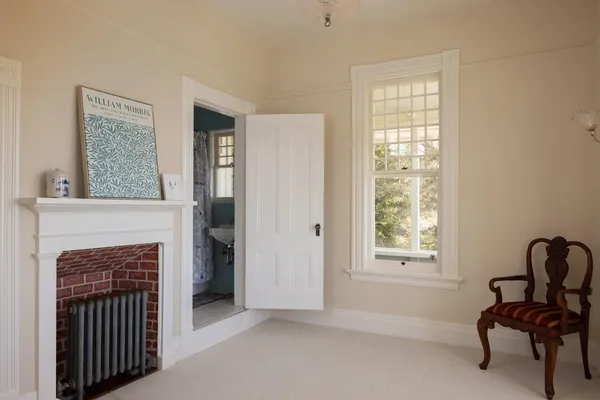 a view of a room that has a window and wooden floor
