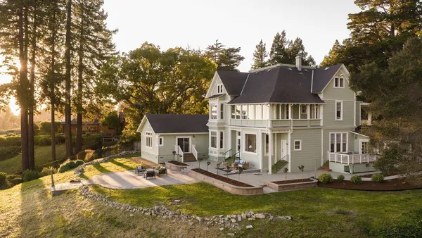 a front view of a house with a yard table and chairs