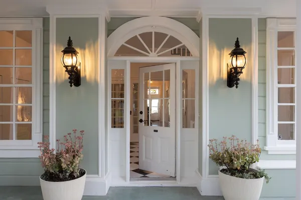 a front view of a house with potted plants