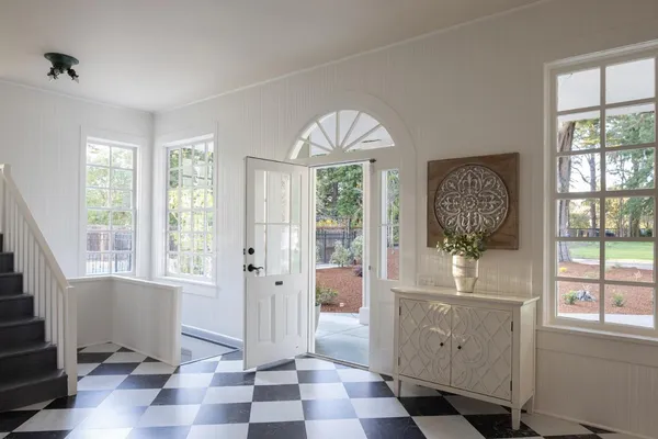 a view of entryway with wooden floor and windows