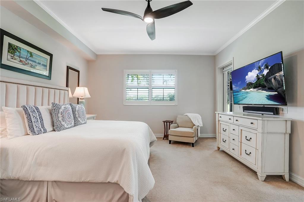 9350 Triana Terrace, Unit 292 Fort Myers, FL 33912 - Photo 14 of 28 a bedroom with a bed and a flat screen tv