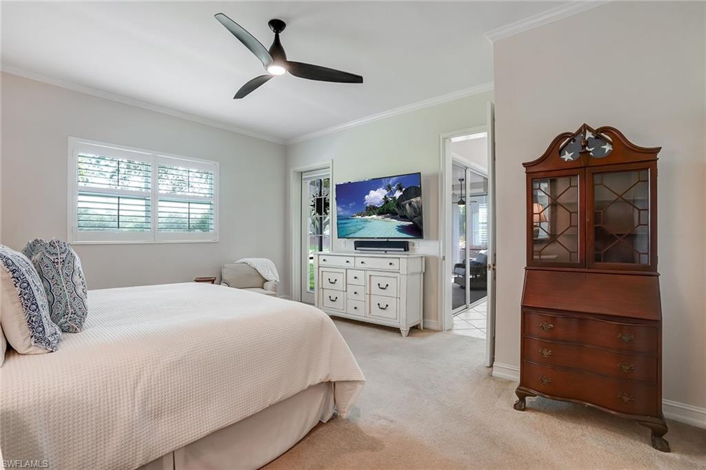 9350 Triana Terrace, Unit 292 Fort Myers, FL 33912 - Photo 16 of 28 a bedroom with a bed and a flat tv screen on dresser
