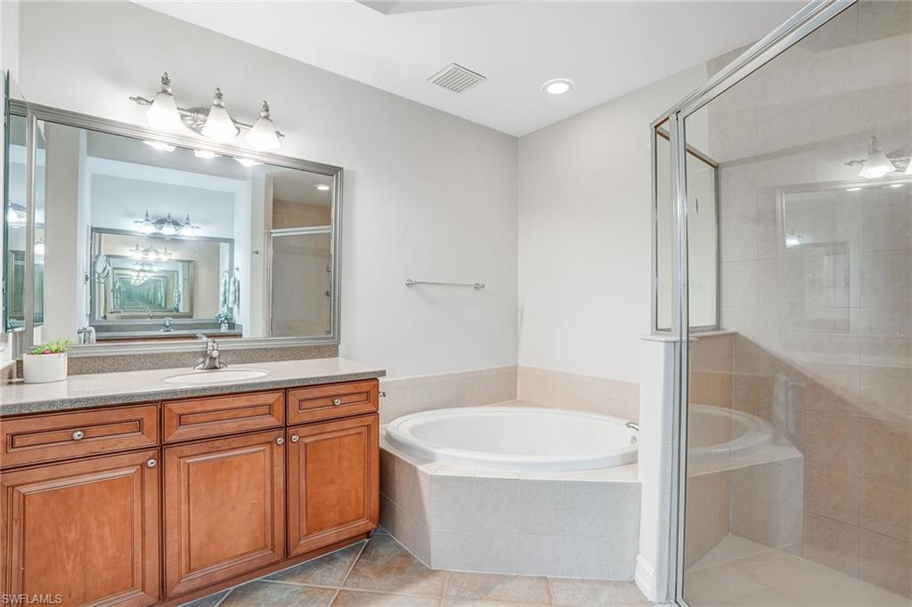 9350 Triana Terrace, Unit 292 Fort Myers, FL 33912 - Photo 17 of 28 a bathroom with a tub a sink and mirror