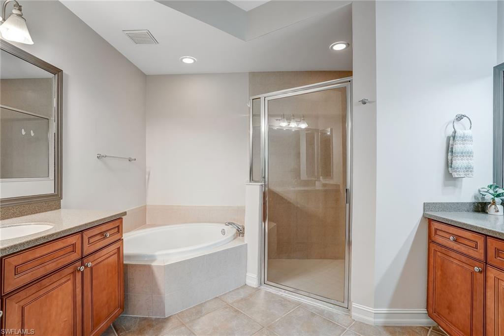 9350 Triana Terrace, Unit 292 Fort Myers, FL 33912 - Photo 18 of 28 a bathroom with a bathtub and a shower