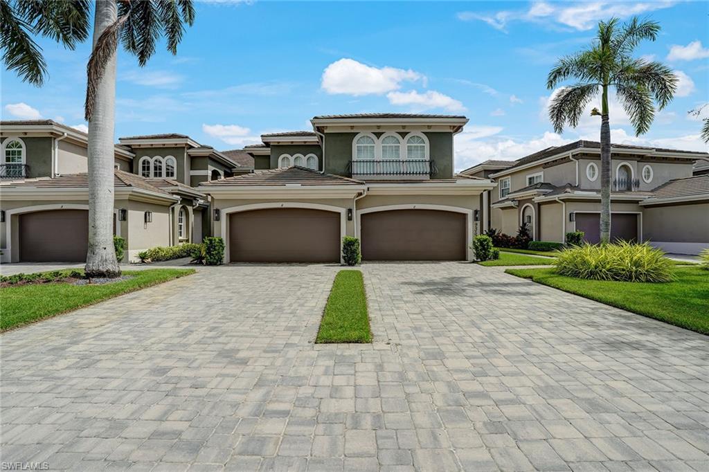 9350 Triana Terrace, Unit 292 Fort Myers, FL 33912 - Photo 2 of 28 a front view of a house with a garden