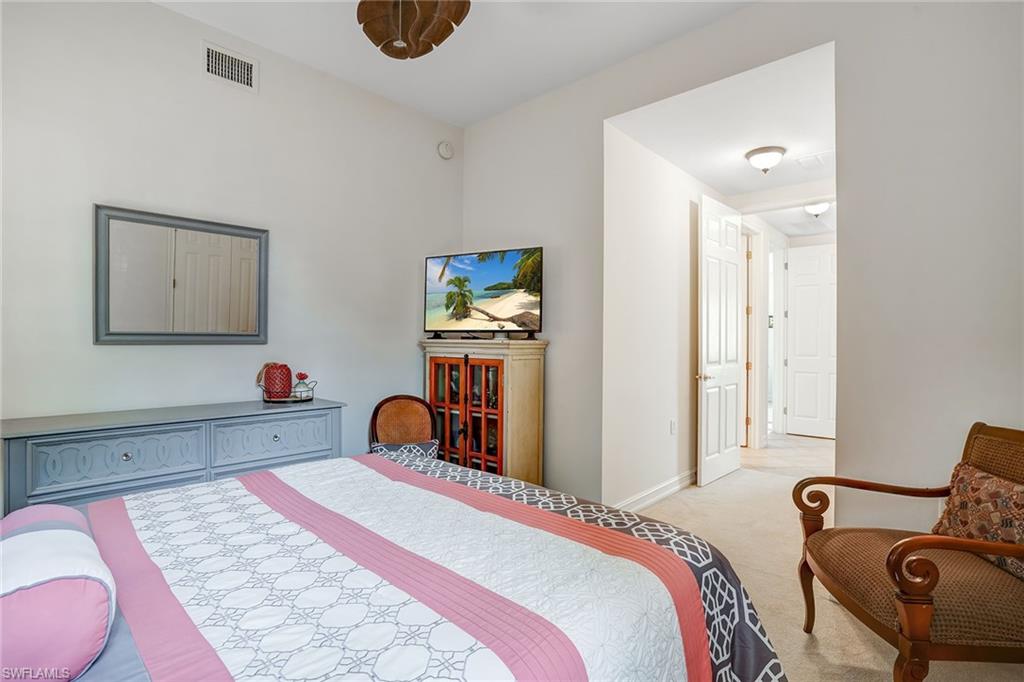 9350 Triana Terrace, Unit 292 Fort Myers, FL 33912 - Photo 21 of 28 a bedroom with a bed and dresser