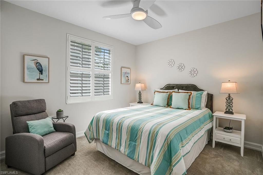 9350 Triana Terrace, Unit 292 Fort Myers, FL 33912 - Photo 23 of 28 a bedroom with a bed and a couch