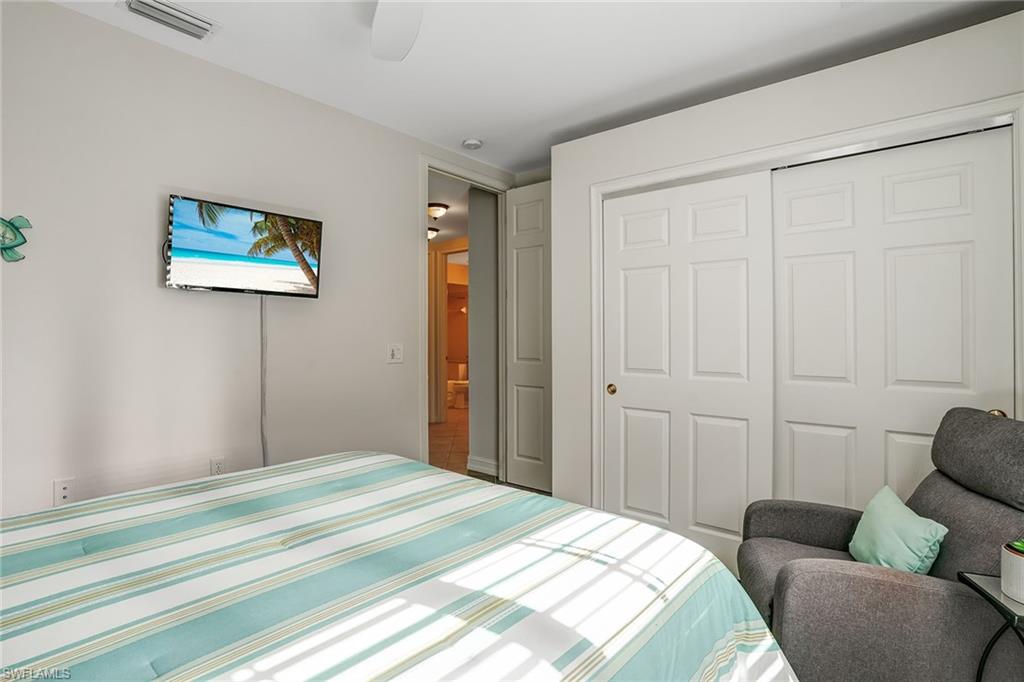 9350 Triana Terrace, Unit 292 Fort Myers, FL 33912 - Photo 24 of 28 a bedroom with a bed and a couch