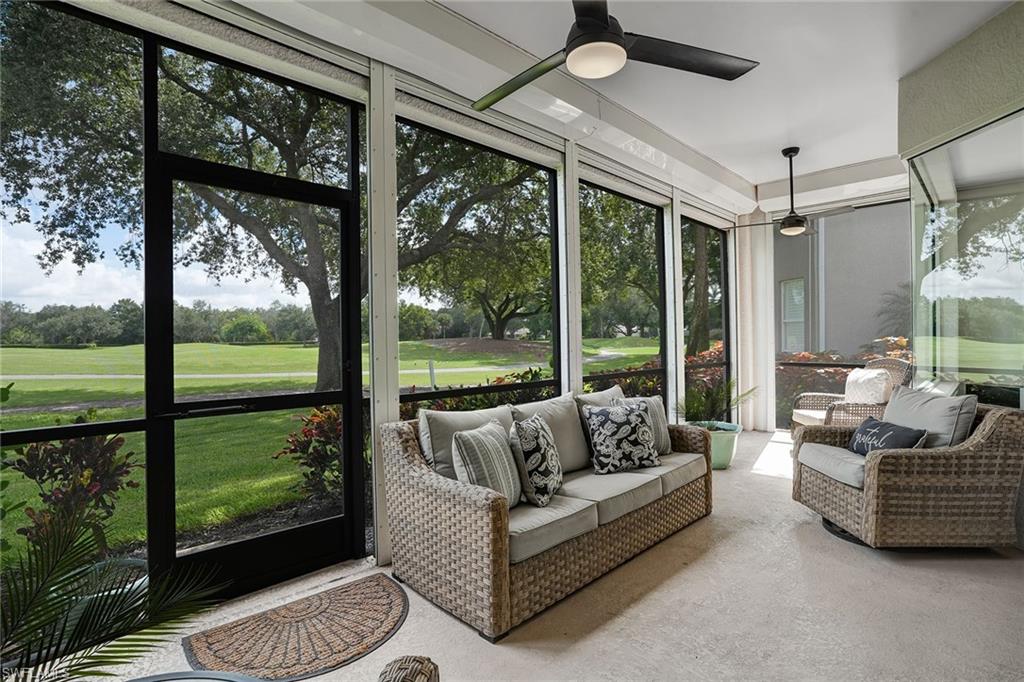 9350 Triana Terrace, Unit 292 Fort Myers, FL 33912 - Photo 25 of 28 a living room with patio furniture and a floor to ceiling window