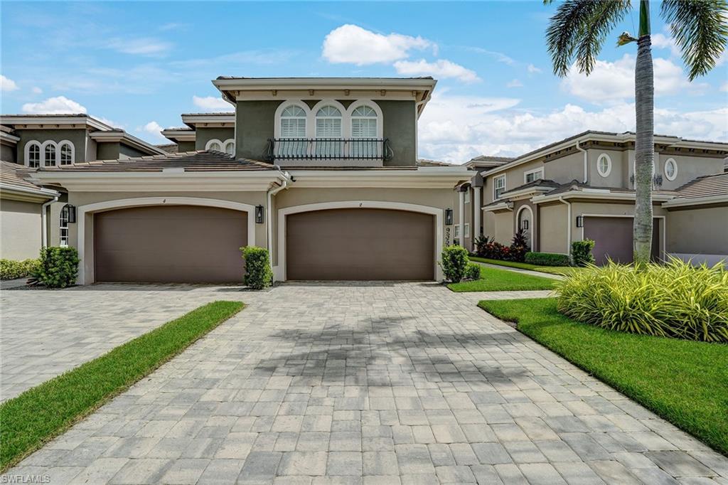 9350 Triana Terrace, Unit 292 Fort Myers, FL 33912 - Photo 28 of 28 a front view of a house with a garden and palm trees