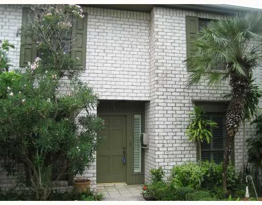 a front view of a house with plants