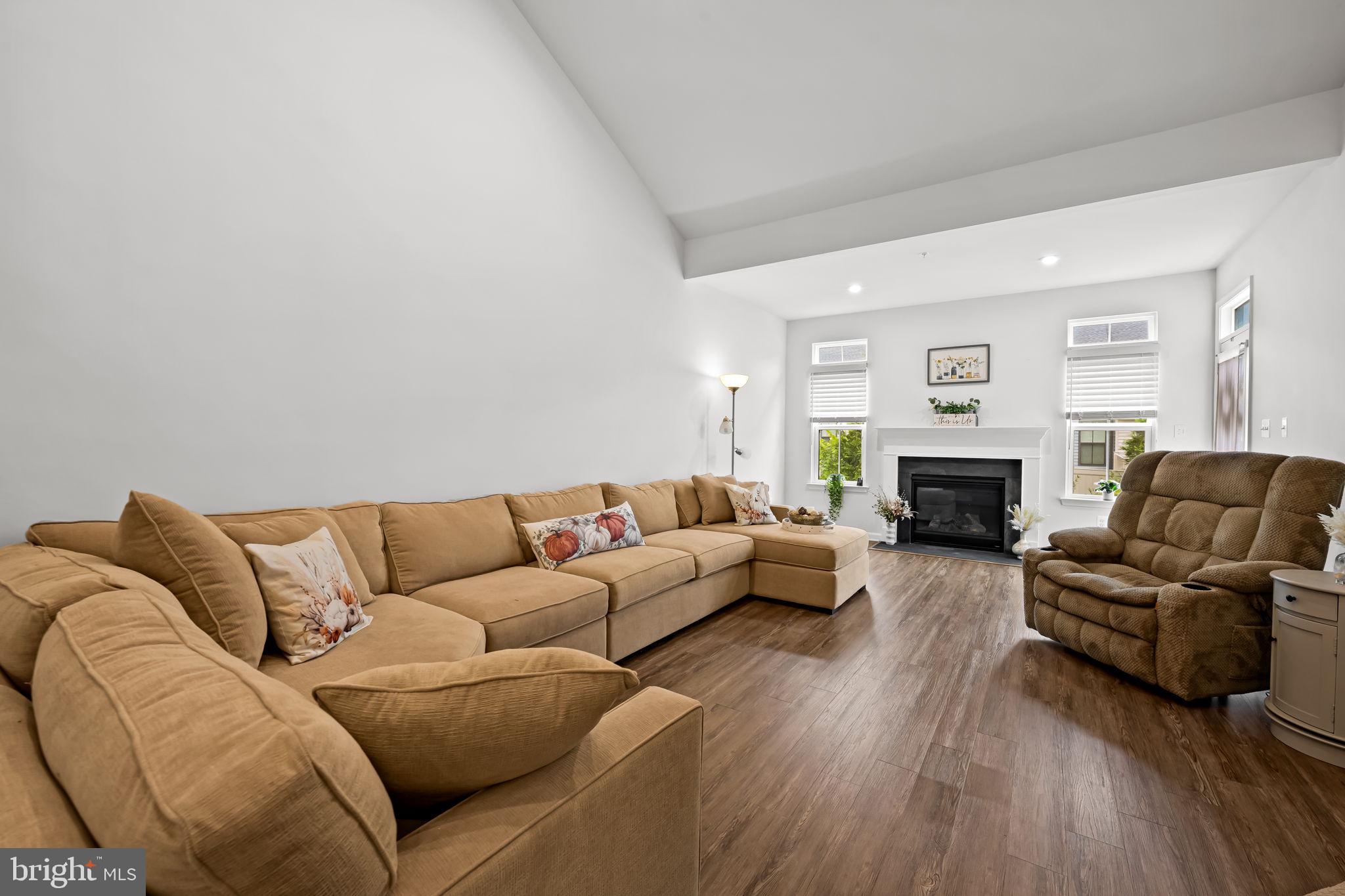 7728 Pestle Lane Glen Burnie, MD 21060 - Photo 15 of 66 a living room with furniture a fireplace and a couch