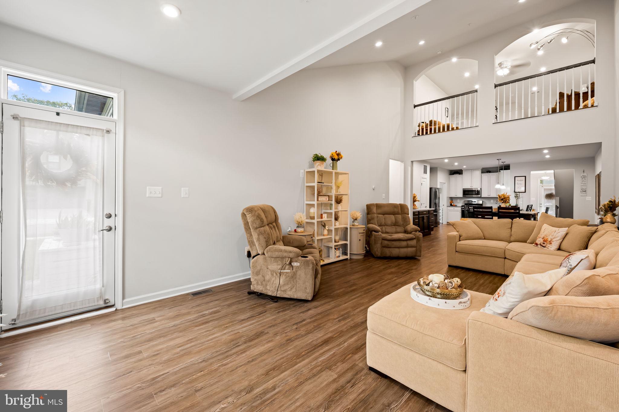 7728 Pestle Lane Glen Burnie, MD 21060 - Photo 17 of 66 a living room with furniture and a wooden floor