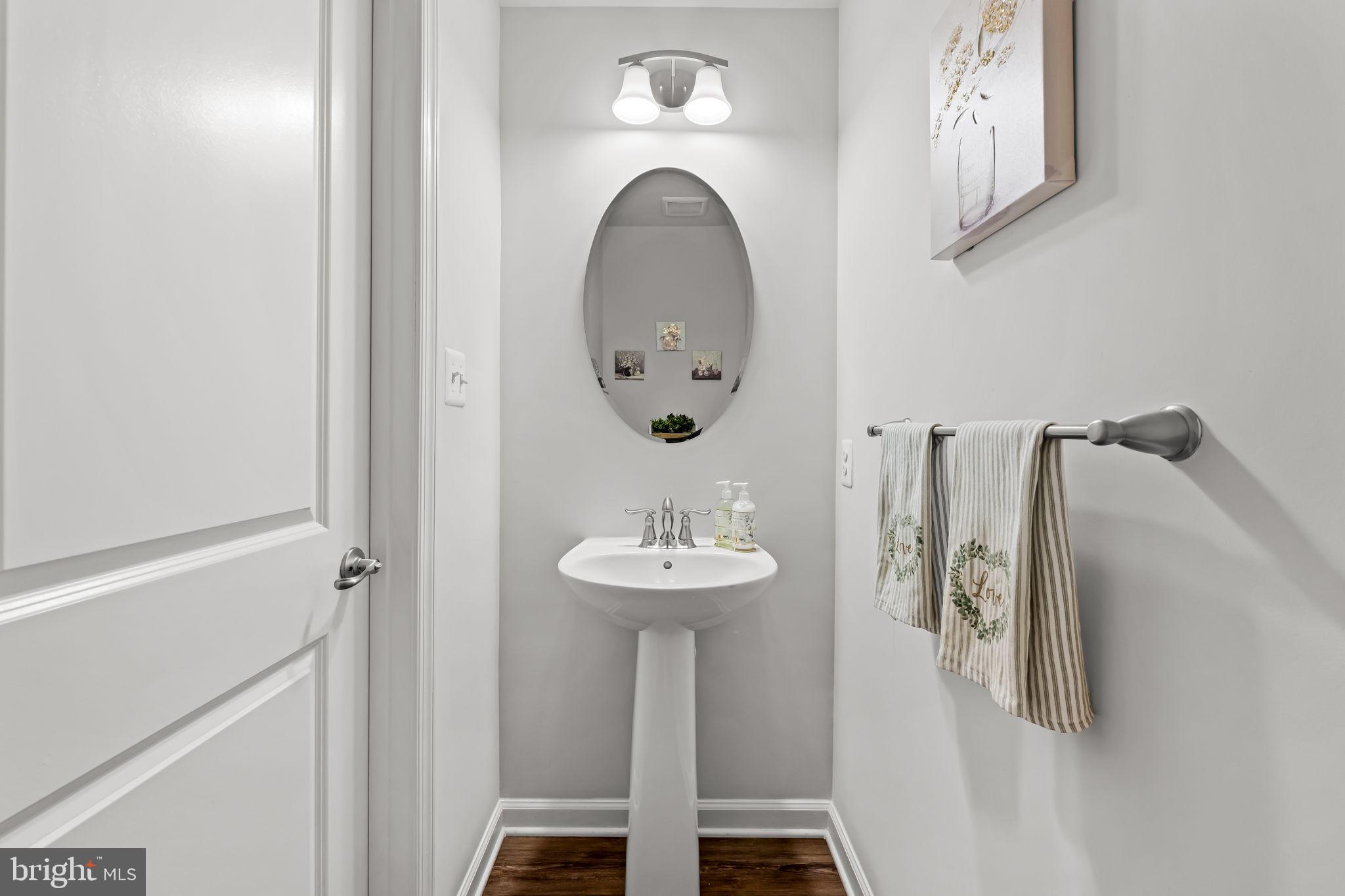 7728 Pestle Lane Glen Burnie, MD 21060 - Photo 18 of 66 a bathroom with a sink and a mirror
