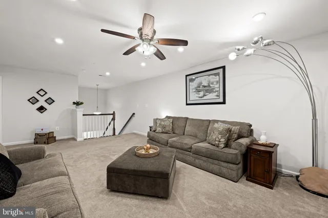 a bedroom with a bed and a ceiling fan