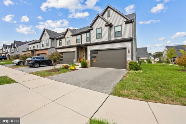 a kitchen with granite countertop white cabinets and stainless steel appliances
