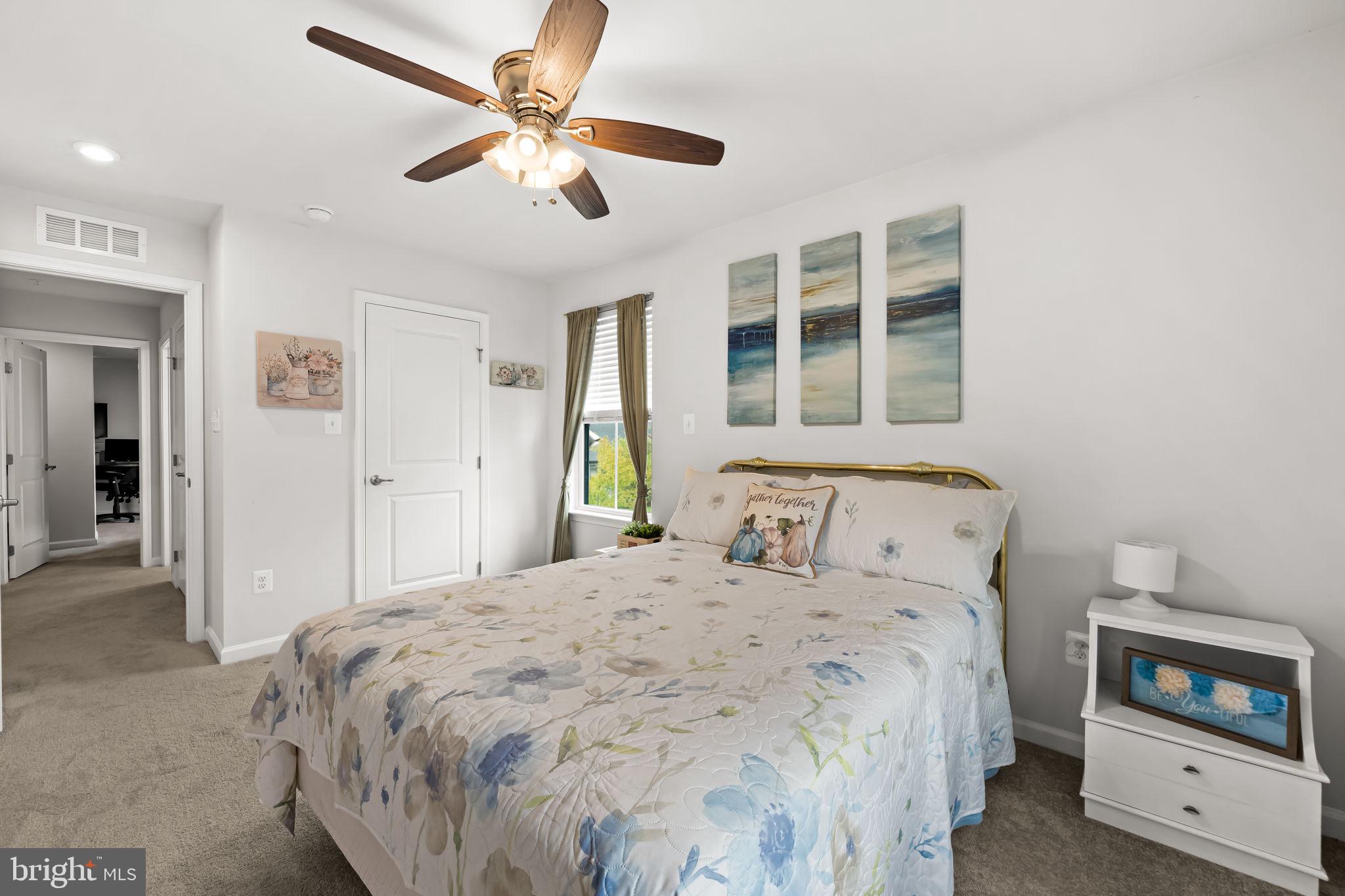 7728 Pestle Lane Glen Burnie, MD 21060 - Photo 31 of 66 a bedroom with a bed and a ceiling fan