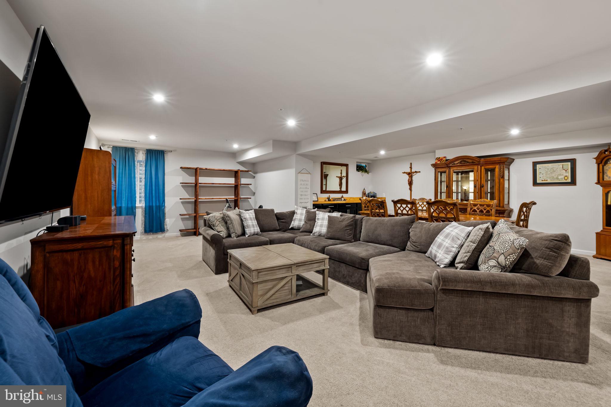 7728 Pestle Lane Glen Burnie, MD 21060 - Photo 37 of 66 a living room with furniture fireplace and a flat screen tv