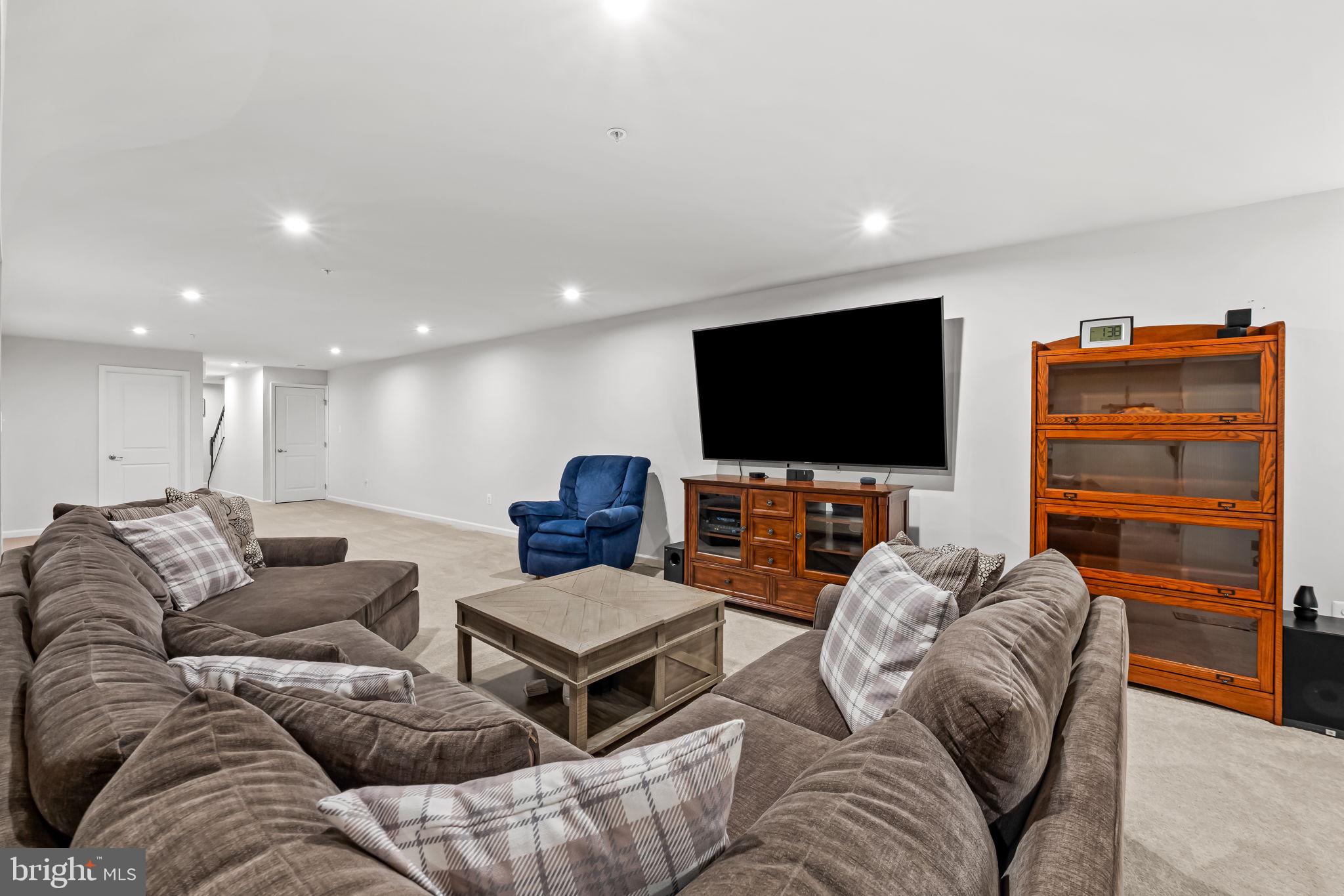 7728 Pestle Lane Glen Burnie, MD 21060 - Photo 39 of 66 a living room with furniture and a flat screen tv