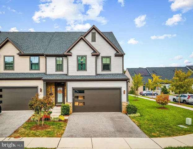 a front view of house with yard outdoor seating and green space